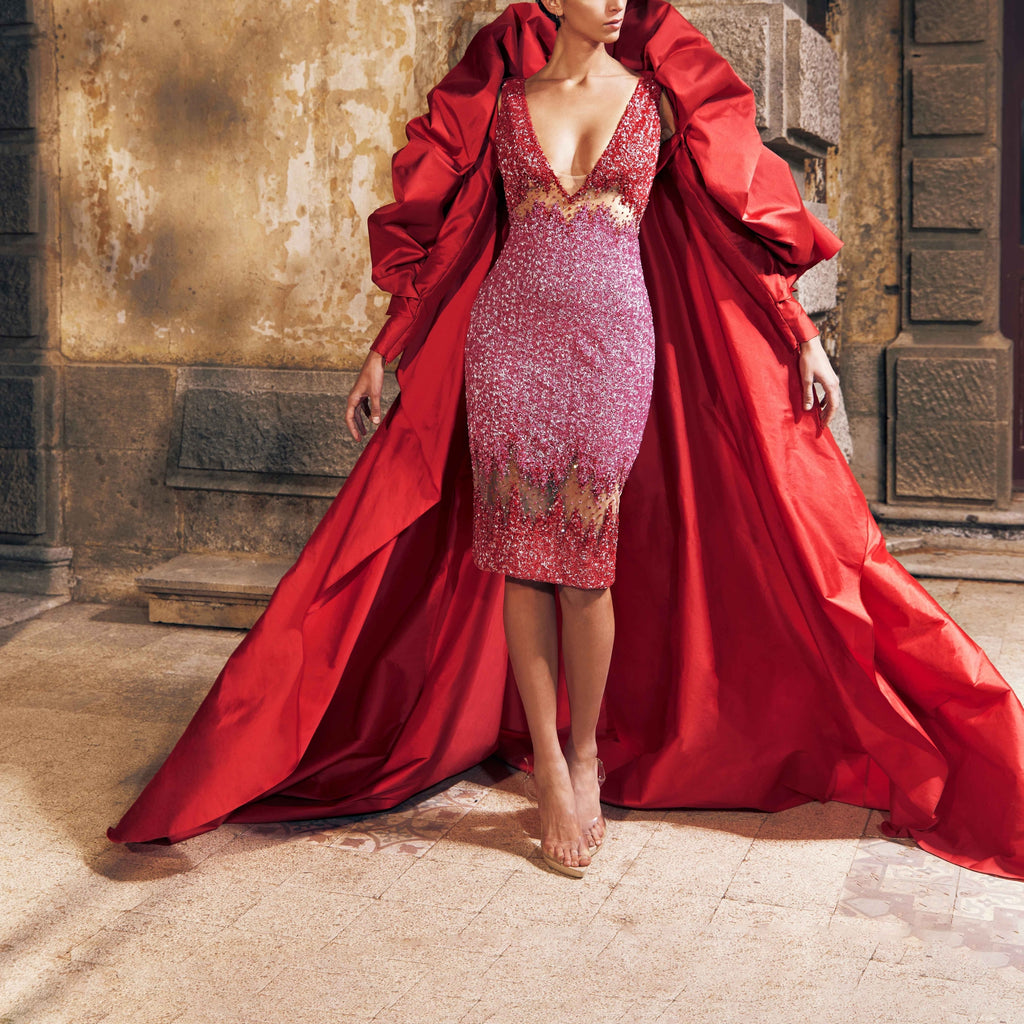 Red and fuchsia sequin cut out midi dress featuring a detachable taffeta cape with voluminous detailing